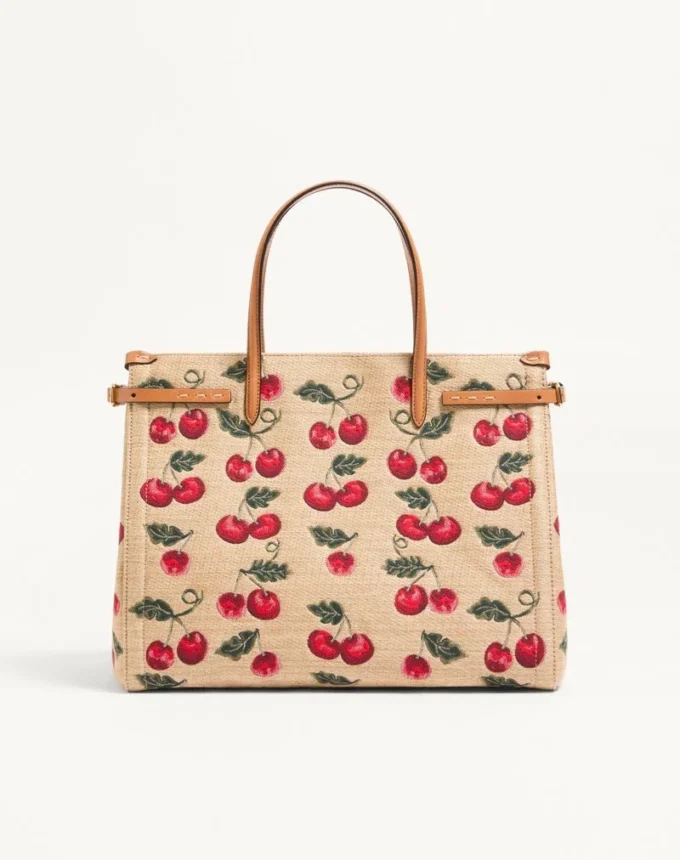 Geantă de cumpărături medie Valentino Garavani Antibes din rafie jacquard cu motiv Cherryfic Geantă de cumpărături medie Valentino Garavani Antibes din rafie jacquard cu motiv Cherryfic