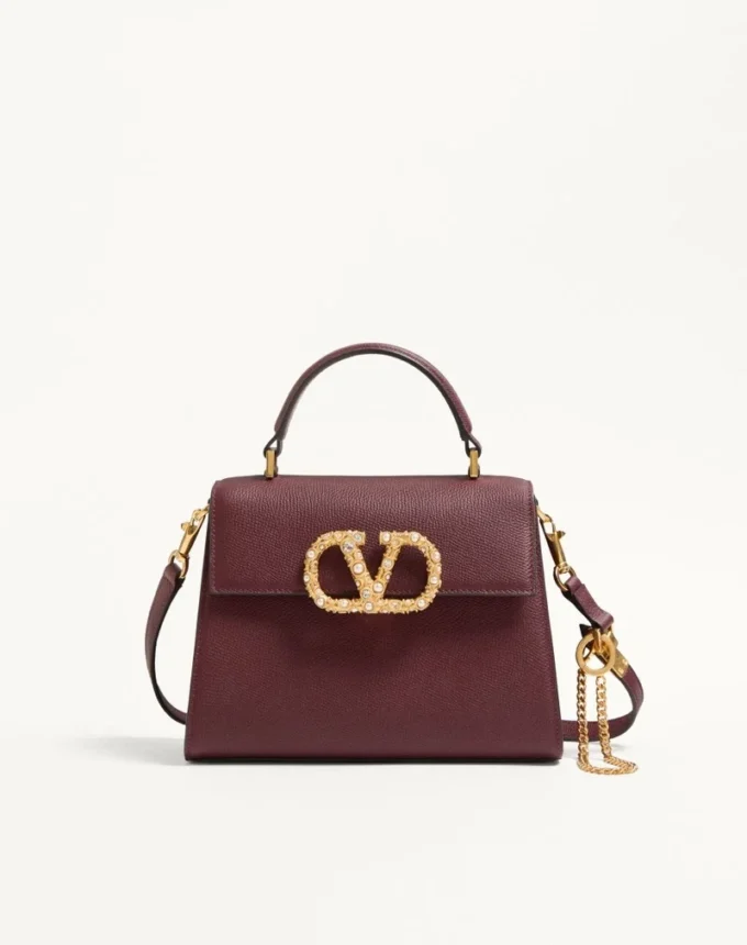 Geantă de mână Valentino Garavani Vsling din piele de vițel granată cu logo bijuterie Geantă de mână Valentino Garavani Vsling din piele de vițel granată cu logo bijuterie