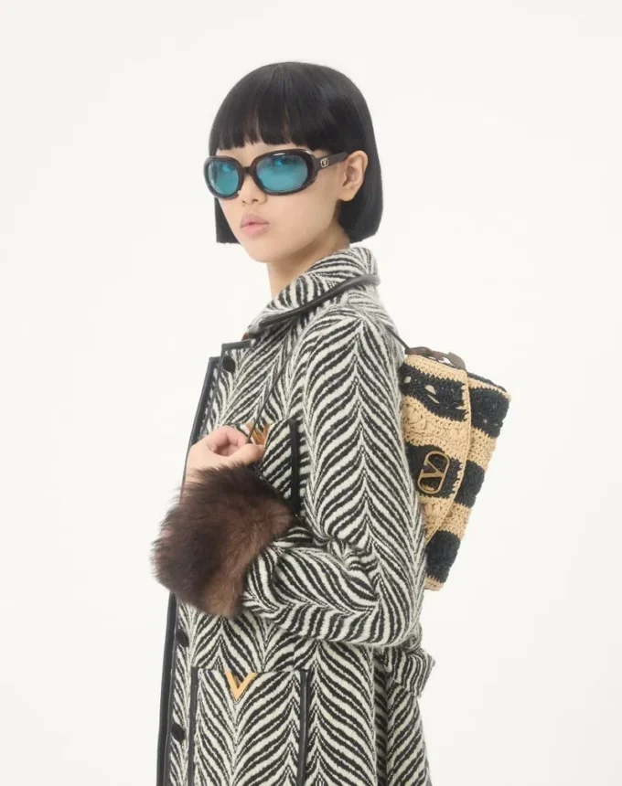 Geantă de umăr mică Valentino Garavani DeVain din rafie cu model ondulat Geantă de umăr mică Valentino Garavani DeVain din rafie cu model ondulat