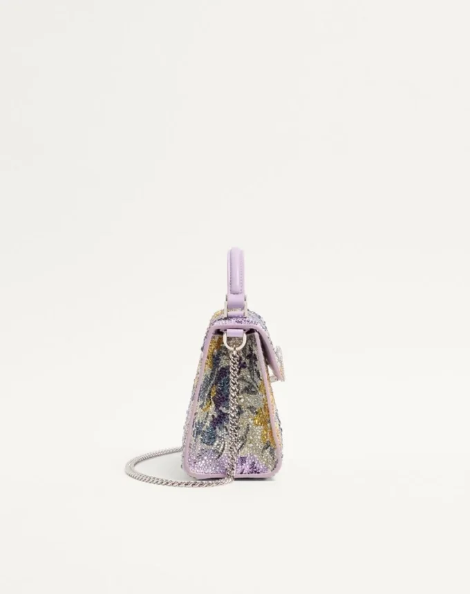 Mini geantă de mână Valentino Garavani Vsling cu motiv Flowerism din strasuri și logo bijuterie Mini geantă de mână Valentino Garavani Vsling cu motiv Flowerism din strasuri și logo bijuterie