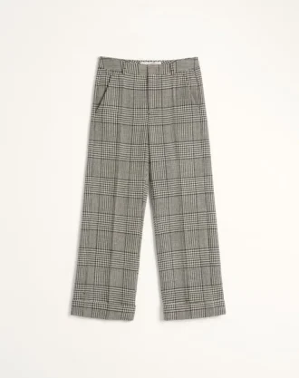 Pantaloni din lână cu revere și model în carouri pe fundal houndstooth