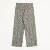 Pantaloni din lână cu revere și model în carouri pe fundal houndstooth
