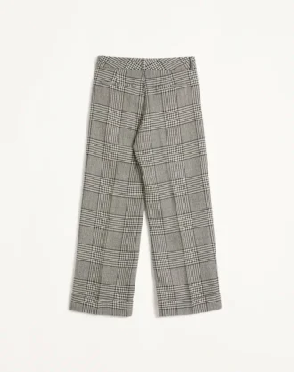 Pantaloni din lână cu revere și model în carouri pe fundal houndstooth