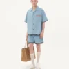 Pantaloni scurți din denim cu imprimeu floral pe tiv Pantaloni scurți din denim cu imprimeu floral pe tiv